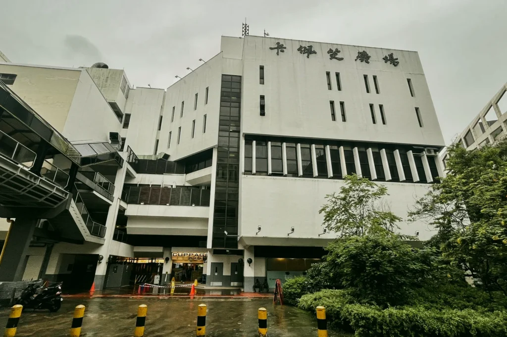 Low-angle wide shot of Cuppage Plaza exterior near Orchard Road Singapore, a hidden gem for authentic Japanese dining and izakaya restaurants popular with Japanese expats