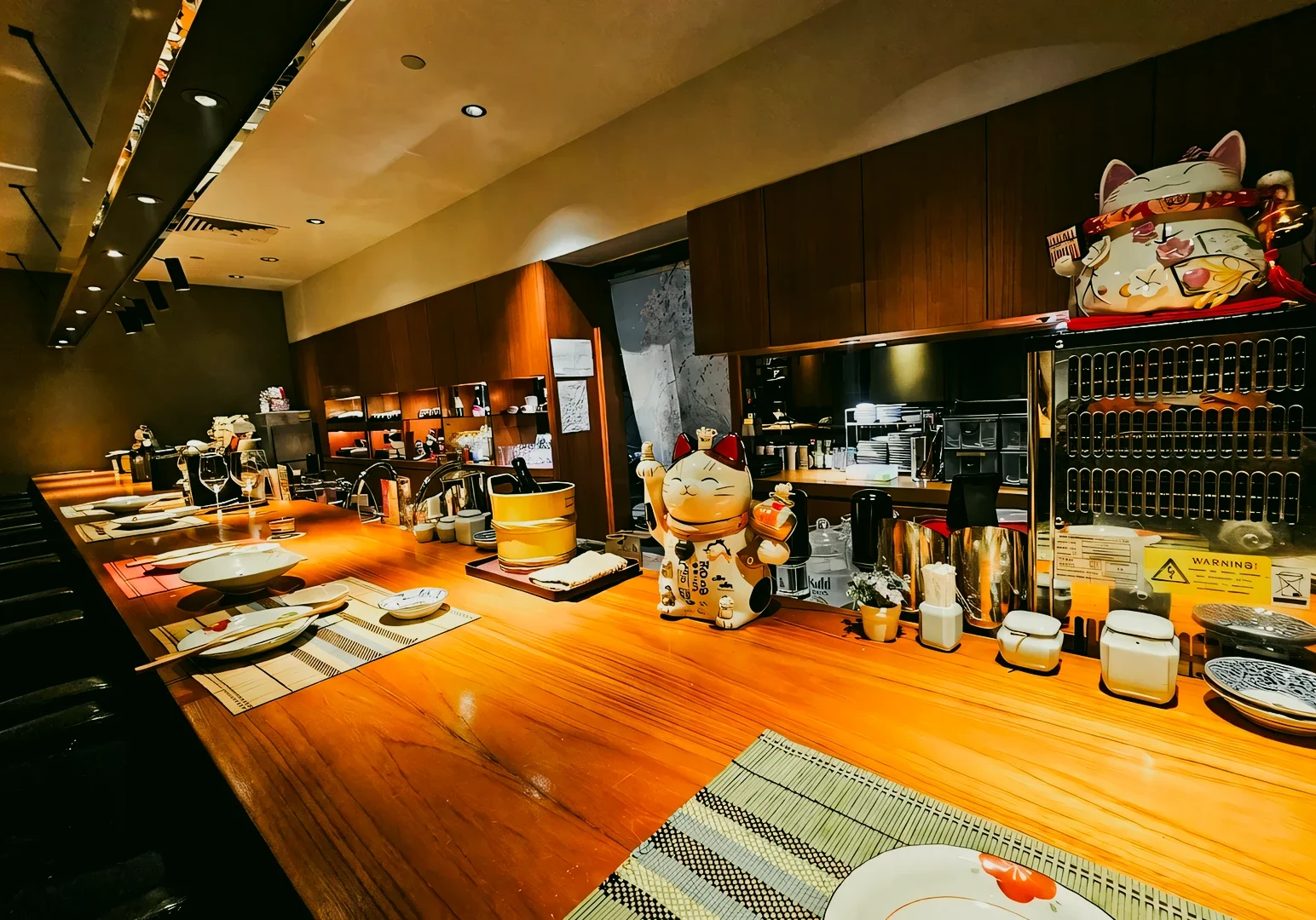 1 Hanashizuku Japanese Cuisine Wide-angle eye-level shot of Hanashizuku Japanese Cuisine sushi counter in Cuppage Plaza Singapore, featuring minimalist wood interior, warm lighting, and authentic Japanese dining setup