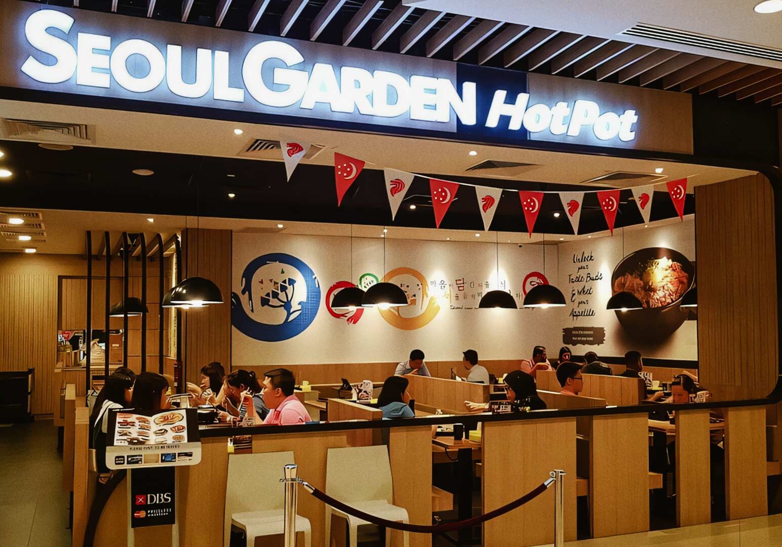 Seoul Garden HotPot restaurant exterior with diners enjoying Korean cuisine.