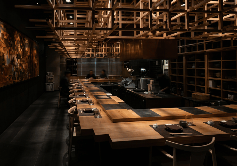 izakaya-afterwork-sg- (1) A moody, modern izakaya interior featuring a long L-shaped wooden dining counter and an intricate, contemporary wooden lattice structure on the ceiling.