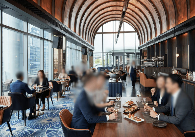 luxury-dining-traditional- (1) Patrons dressed in business attire dine in a sophisticated, modern restaurant with high, arched wooden ceilings, expansive windows, and a vibrant blue patterned carpet, evoking the atmosphere of a beloved gathering place.